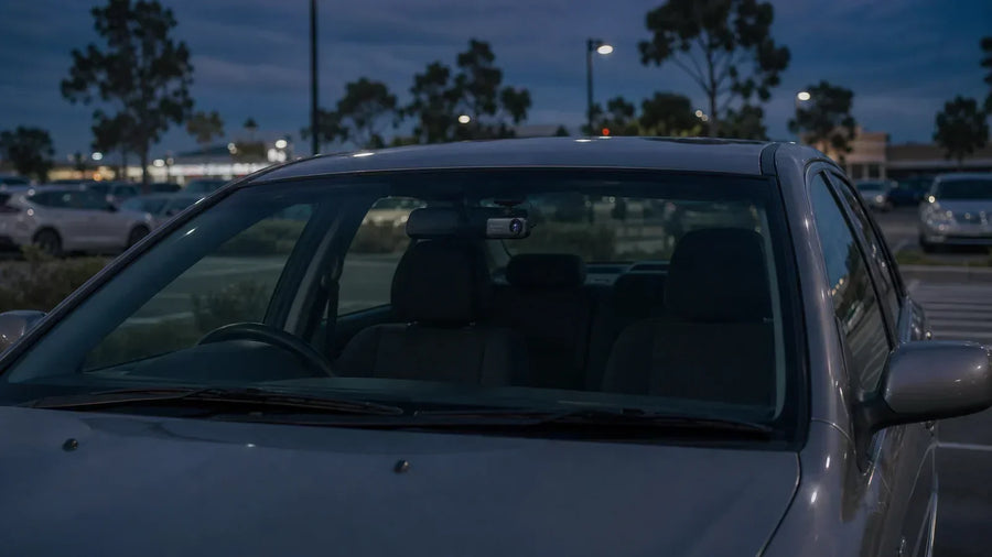 Dash cam monitoring a parked car at night in an Australian car park