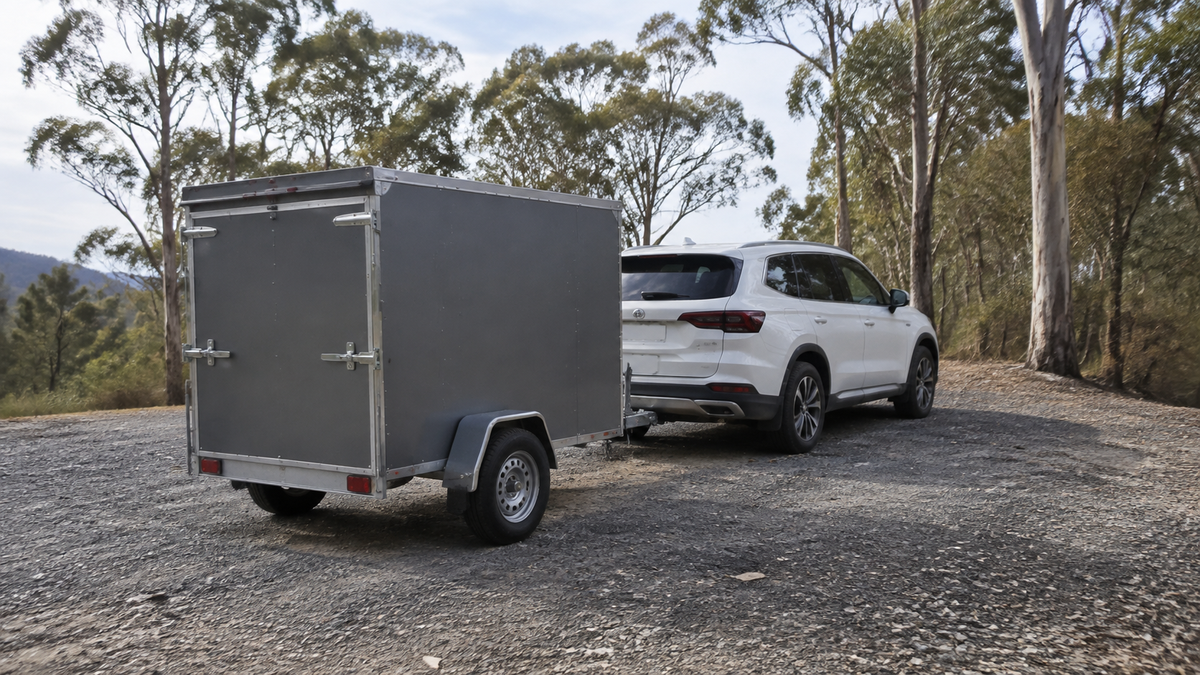 Illustrative SUV and enclosed trailer parked at a rural Australian pull-off