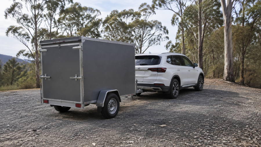 Illustrative SUV and enclosed trailer parked at a rural Australian pull-off